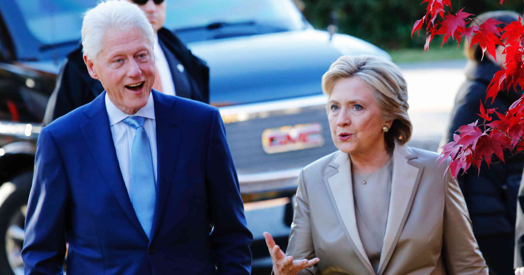 Democratic presidential nominee Hillary Clinton talks with her husband and former U.S. president Bill Clinton after casting her vote in Chappaqua, New York on November 08, 2016.